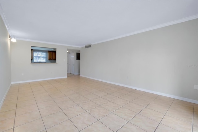 tiled empty room featuring crown molding