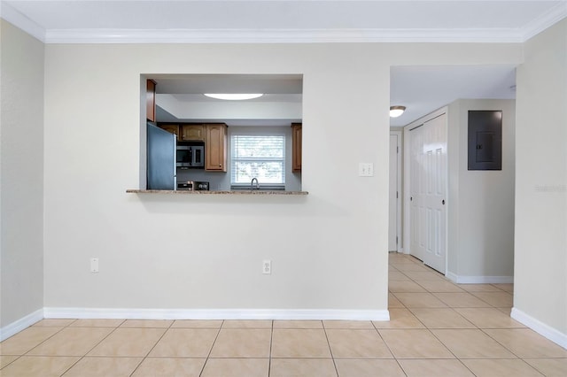 interior space featuring crown molding, electric panel, stainless steel appliances, and light tile patterned flooring