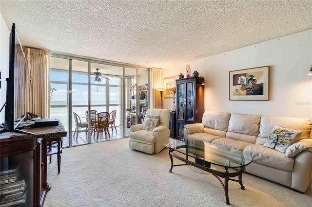 living room with carpet flooring, a textured ceiling, floor to ceiling windows, and ceiling fan