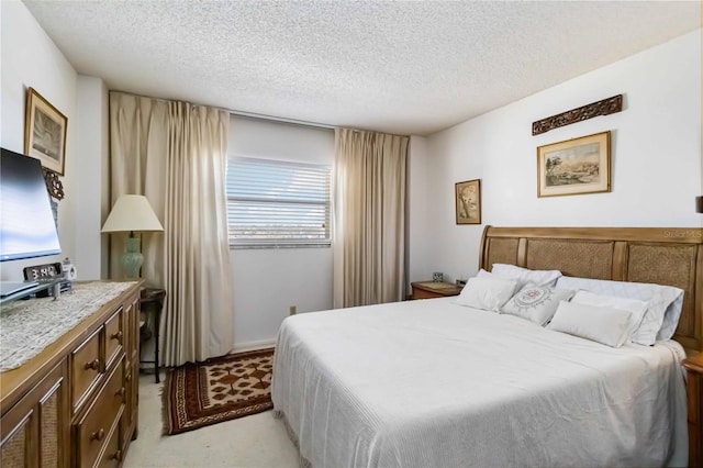 carpeted bedroom with a textured ceiling