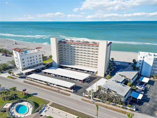 birds eye view of property with a beach view and a water view