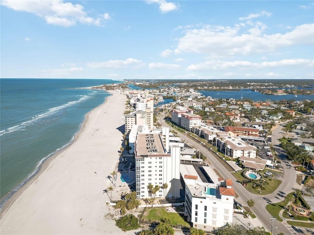 drone / aerial view with a water view and a beach view