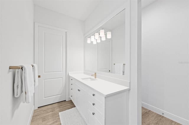 bathroom featuring hardwood / wood-style flooring and vanity