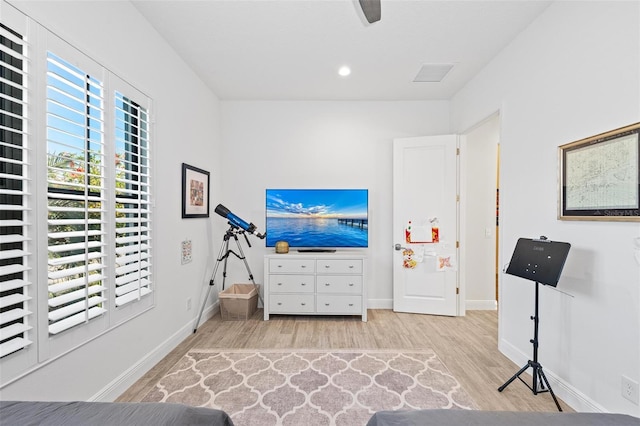 interior space with ceiling fan and light wood-type flooring