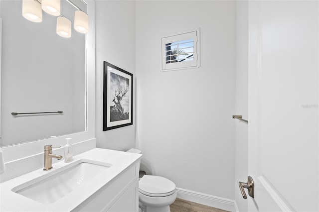 bathroom featuring vanity, toilet, and hardwood / wood-style floors