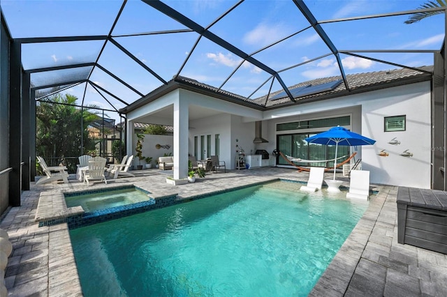 view of swimming pool with an in ground hot tub, a lanai, and a patio area