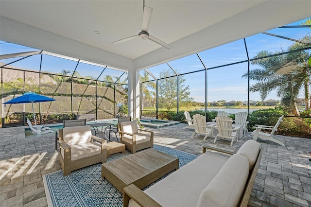 view of patio featuring a lanai, an outdoor hangout area, ceiling fan, and a pool with hot tub