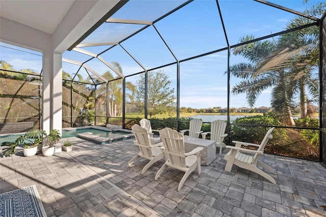 view of patio featuring a pool with hot tub, a lanai, and a water view