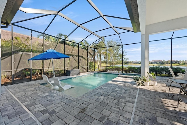 view of swimming pool featuring a water view, an in ground hot tub, a lanai, and a patio area