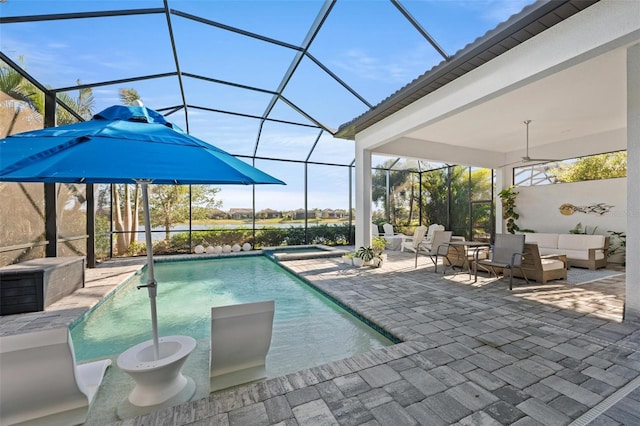 view of swimming pool featuring outdoor lounge area, a patio area, ceiling fan, and a lanai