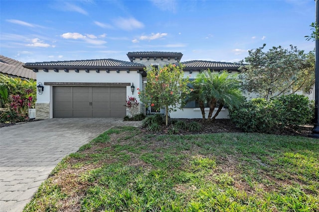 mediterranean / spanish-style house with a garage