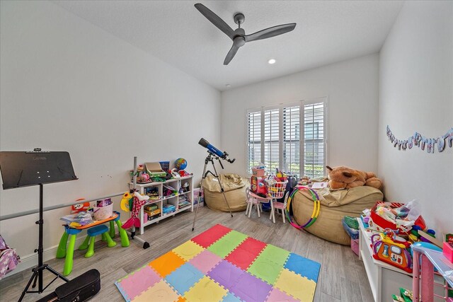 game room with ceiling fan and wood finished floors