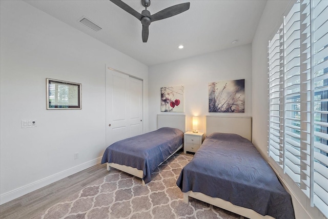 bedroom featuring recessed lighting, visible vents, a ceiling fan, wood finished floors, and baseboards