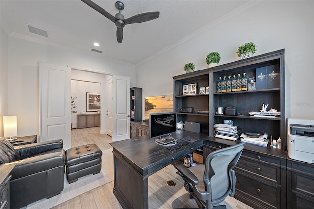 office space featuring crown molding, visible vents, ceiling fan, and wood finished floors