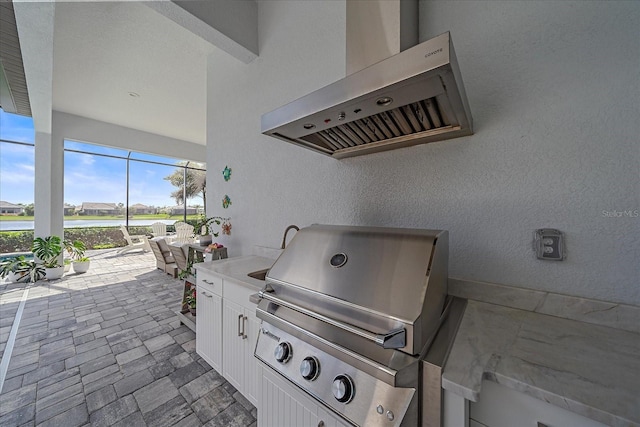 view of patio / terrace with an outdoor kitchen, a grill, and a lanai