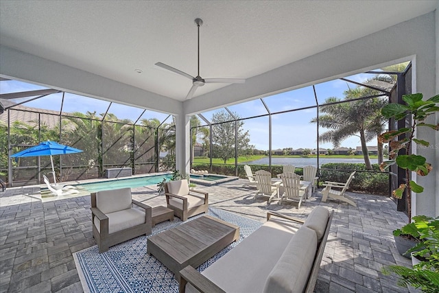 view of patio with a lanai, ceiling fan, an outdoor pool, and an outdoor living space