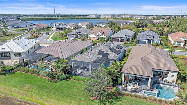 birds eye view of property featuring a water view and a residential view