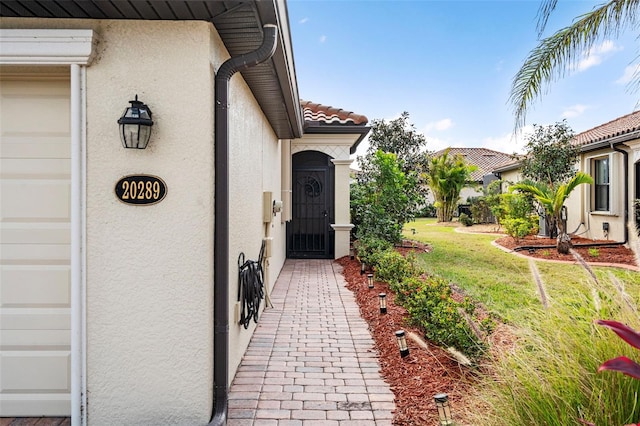 entrance to property with a lawn