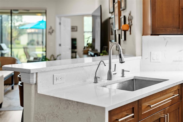 kitchen featuring tasteful backsplash and sink