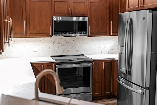 kitchen featuring tasteful backsplash and stainless steel appliances