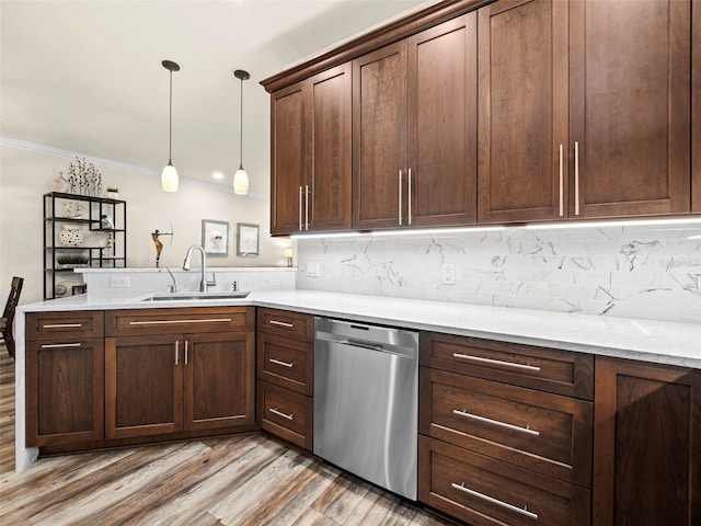 kitchen featuring dishwasher, pendant lighting, kitchen peninsula, sink, and light wood-type flooring