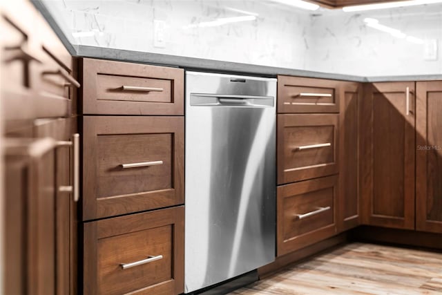 kitchen with stainless steel dishwasher and light wood-type flooring