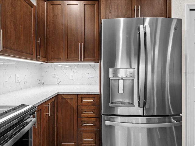 kitchen featuring backsplash, light stone countertops, and stainless steel appliances