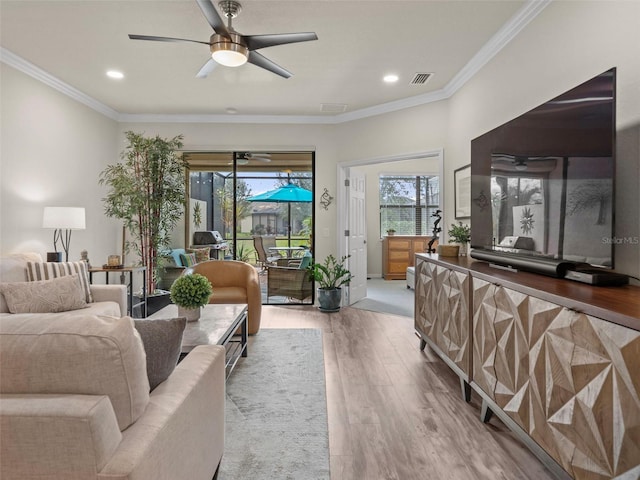 living room with ceiling fan, crown molding, and hardwood / wood-style flooring