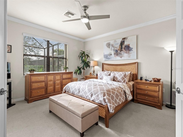 carpeted bedroom with ceiling fan and ornamental molding