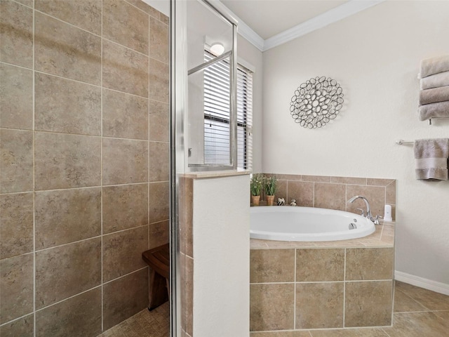 bathroom with tile patterned flooring, crown molding, and shower with separate bathtub