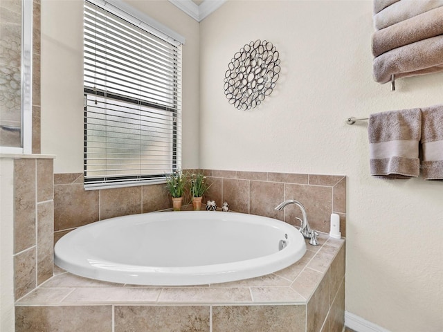 bathroom featuring tiled bath and ornamental molding