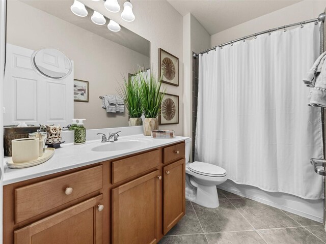 full bathroom with toilet, vanity, shower / tub combo, and tile patterned floors