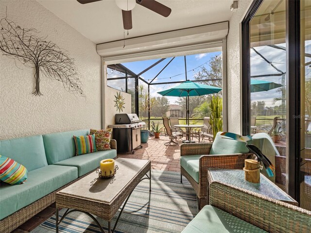 sunroom / solarium featuring ceiling fan