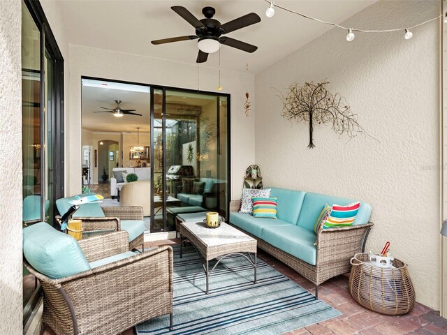 view of patio / terrace with ceiling fan and an outdoor living space