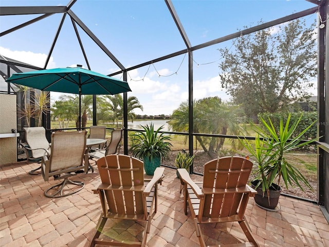 sunroom / solarium featuring a water view