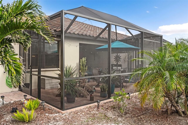 back of house featuring a lanai and a patio