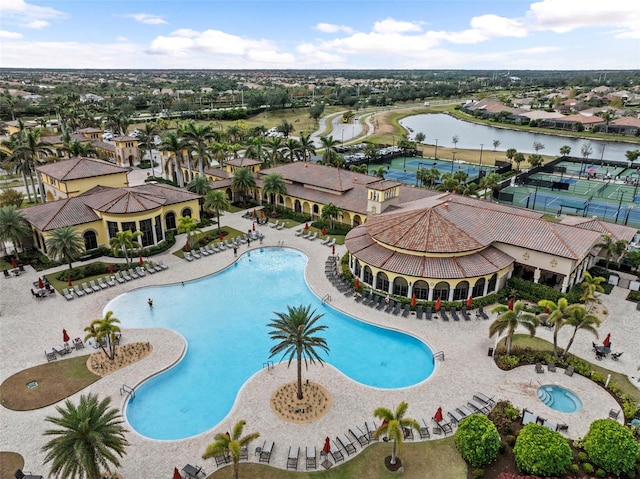 view of pool featuring a patio area and a water view