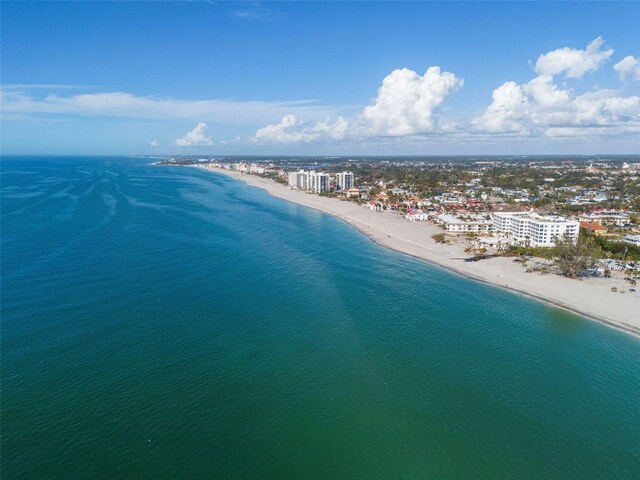 drone / aerial view featuring a beach view and a water view