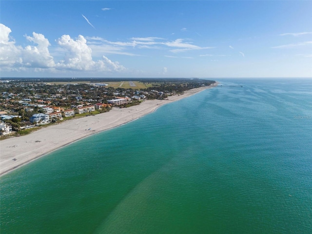 bird's eye view with a water view and a beach view