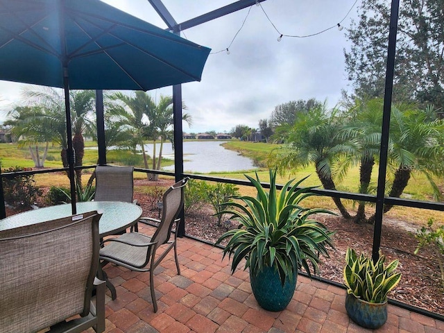 sunroom / solarium with a water view