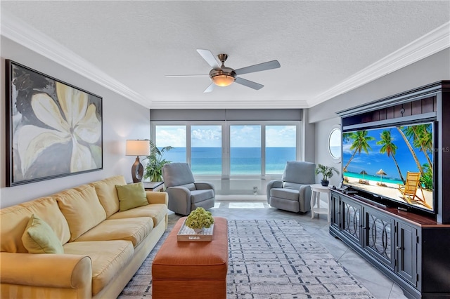 tiled living room featuring a textured ceiling, ceiling fan, and crown molding