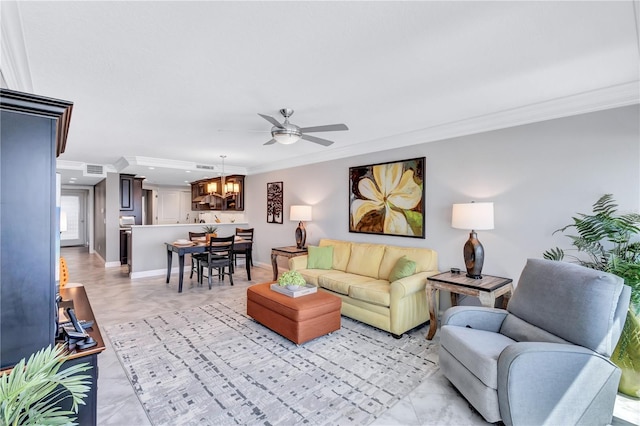 living room featuring ceiling fan with notable chandelier and crown molding