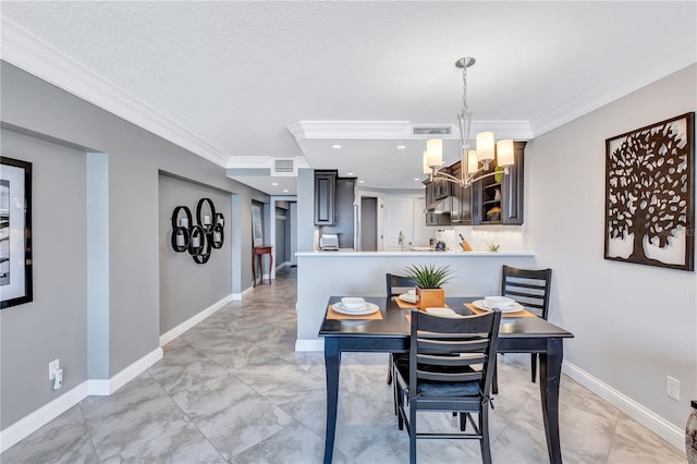 dining space featuring ornamental molding and a notable chandelier