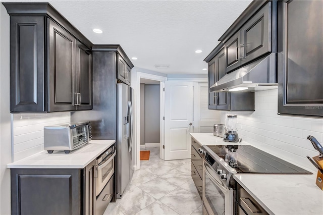 kitchen featuring appliances with stainless steel finishes and tasteful backsplash