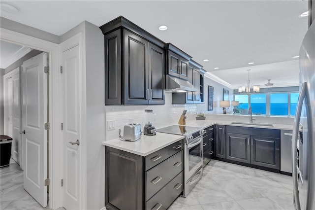 kitchen featuring backsplash, stainless steel appliances, crown molding, sink, and decorative light fixtures