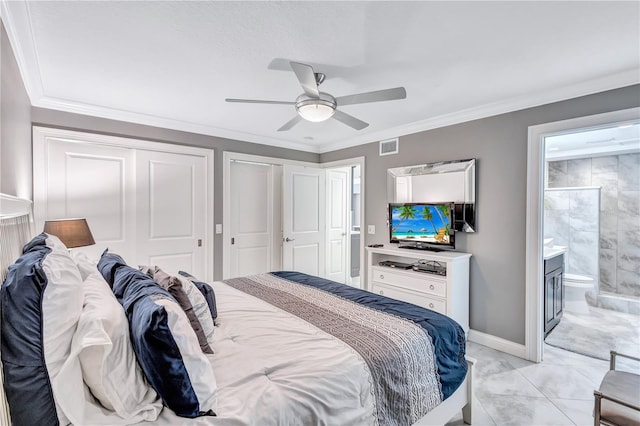 tiled bedroom with ceiling fan, ensuite bath, ornamental molding, and two closets