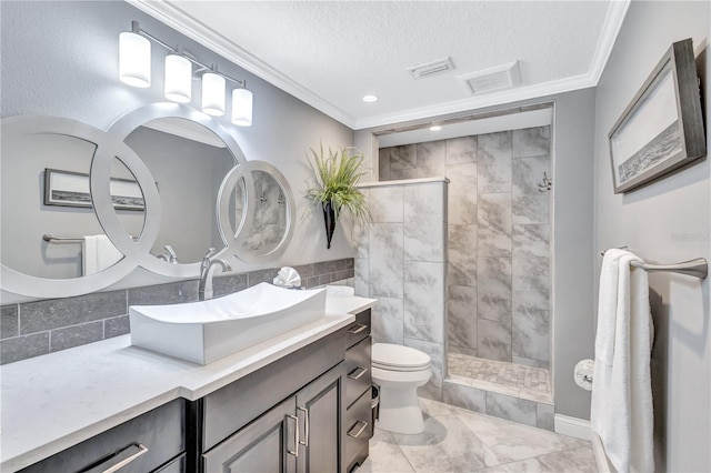 bathroom with a tile shower, a textured ceiling, toilet, vanity, and ornamental molding