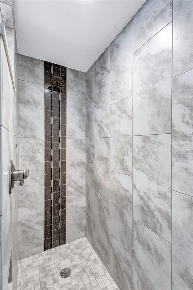 bathroom with tiled shower