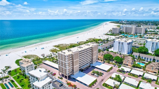 drone / aerial view featuring a water view and a view of the beach