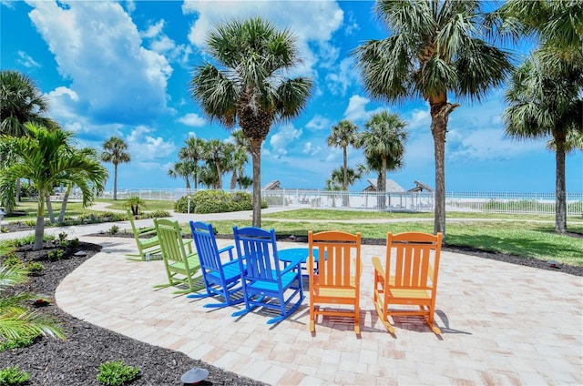 view of patio featuring a water view and a view of the beach